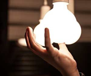 image of hand screwing in a lightbulb